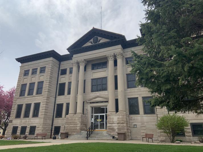 The exterior of the Calhoun County Iowa courthouse, a four-story grey stone building.